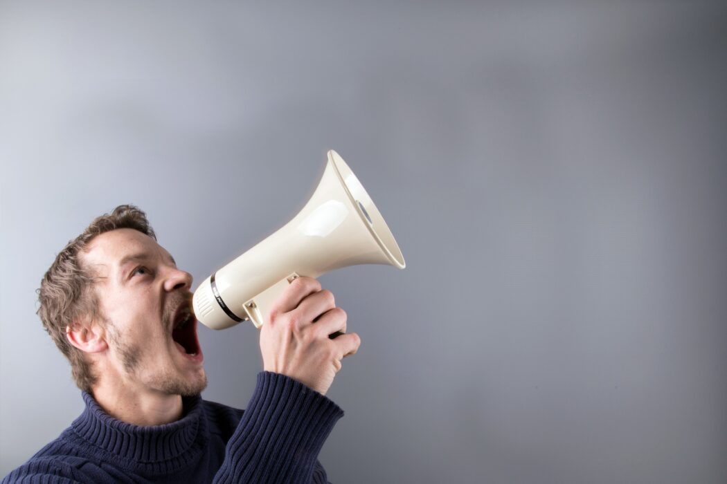 a man yelling into a megaphone