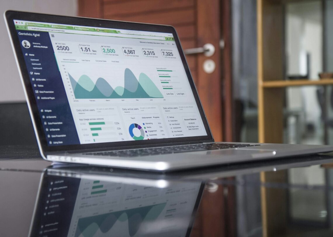 A laptop setting on a desk with website analytics on the screen