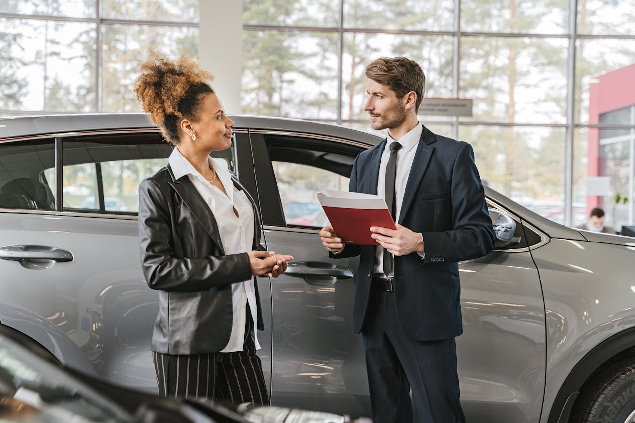 people talking at a Car dealership